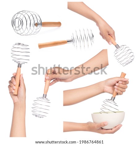 Set of hand holding Balloon whisk manual hand egg beater isolated on a white background Royalty-Free Stock Photo #1986764861