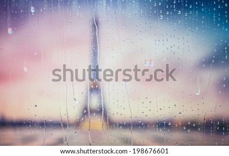 Silhouette of Tour Eiffel through the window with rain drops. France. Paris.