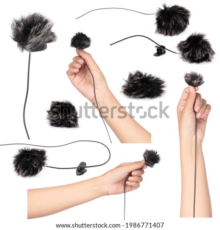 Set of hand holding microphone with fur isolated on white background.