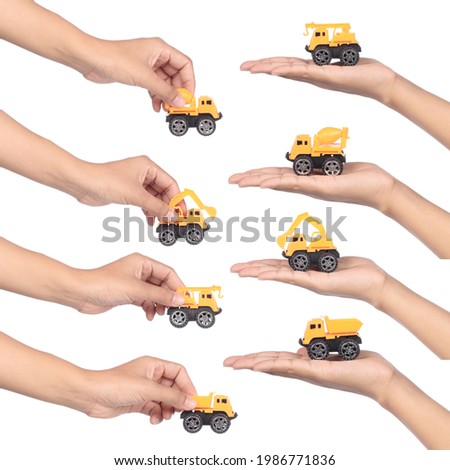 Hand holding constructions truck set isolated on white background.