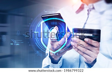 Office woman with smartphone and credit card, lock icon with network symbols in blurred office room. Safe online shopping, transactions. Concept of cyber security and payment