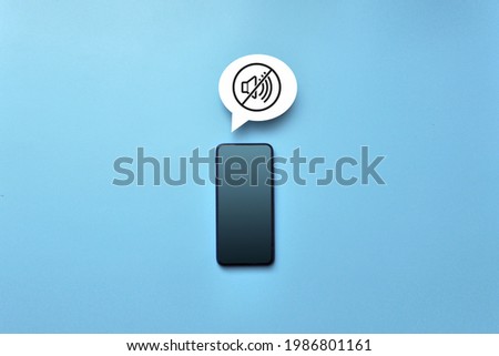 Phone number and the "mute" icon. The symbol of the need to turn off the sound on the phone Royalty-Free Stock Photo #1986801161