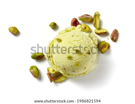 Scoop of pistachio ice cream with pistachio nuts on white background. Top view of ice cream isolated for package design of pistachio ice cream. Royalty-Free Stock Photo #1986821594