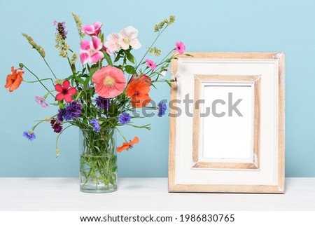 Empty wooden frame with beautiful flowers