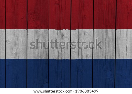 The National Flag of the Netherlands painted on a wooden wall. 
