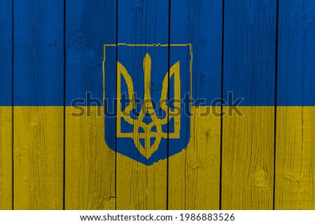 The National Flag of Ukraine painted on a wooden wall.  