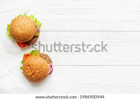 Top view of hamburgers with beef meat steak and vegetales