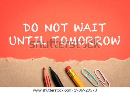 Do Not Wait Until Tomorrow. Office supplies and torn cardboard on a red background.