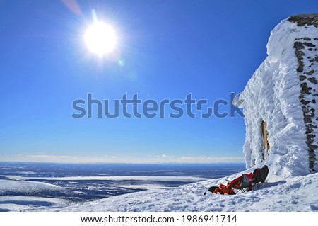 Forsaken ski lift station in front of snow capped landscapes at sunny day, Khibiny, Russian Federation