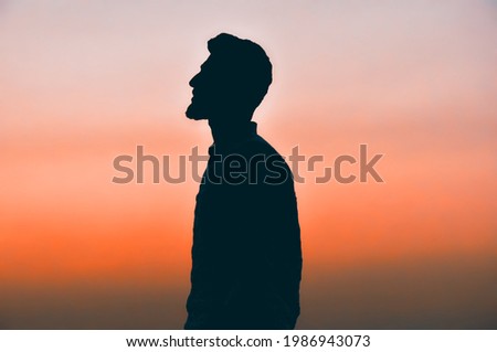 man taking pictures against the sun