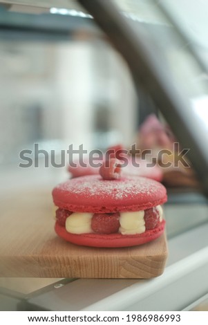 close up Macaroons of different colors on a showcase in a cozy coffee shop.