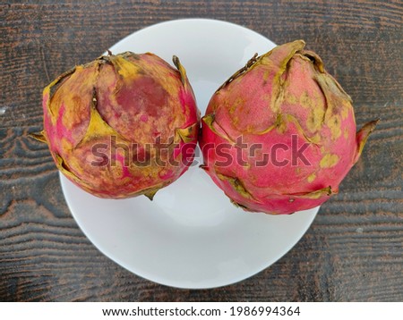 two dragon fruits on a white plate that were cooked and ready to eat