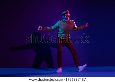Full body photo of charming young happy funny man dance clubber wear sunglass isolated on neon background