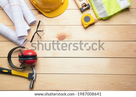 Work safety. Standard Construction site protective equipment on  top view wooden background, flat lay, copy space,safety first concepts.