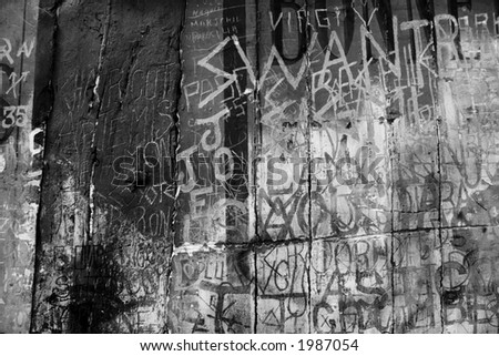 Ancient graffiti etched in to plaster wall. Monochrome. Gritty looking design background for that grunge look.