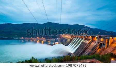 view of the hydroelectric dam, water discharge through locks, long exposure shooting Royalty-Free Stock Photo #1987073498