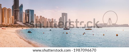 Panoramic views of the Persian Gulf beach and Bluewaters Island with the worlds famous largest Ferris wheel Dubai Eye and numerous skyscrapers with hotels and residences Royalty-Free Stock Photo #1987096670