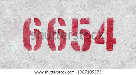 Red Number 6654 on the white wall. Spray paint.