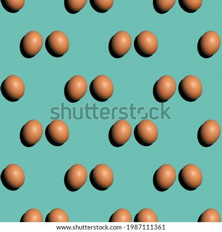 Seamless texture background pattern from eggs on a colored background. Minimal food concept
