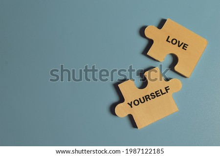 Top view of jigsaw puzzle with text LOVE YOURSELF