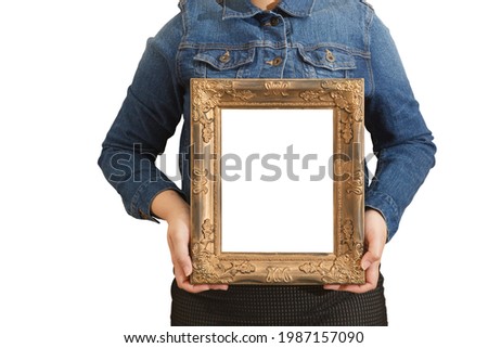 A blank diploma or a mockup certificate in the hand of a woman employee wearing a denim shirt on white background with a clipping path. The vertical picture frame is empty and the copy space.