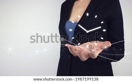 Time management concept. Hand hold digital hologram clock time symbol on grey background. Efficiency strategy goals, Timing Punctual Schedule.