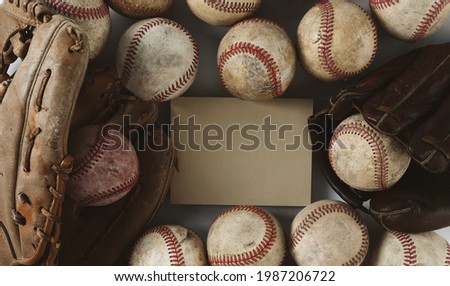 Old grunge retro baseball balls background with copy space on card beside vintage baseballs and glove.