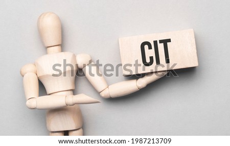 Wooden man shows with a hand to white board with text cit,concept