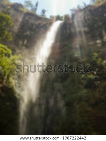 Defocus abstract background of
Waterfall scenery against blue sky background suitable for screen background 