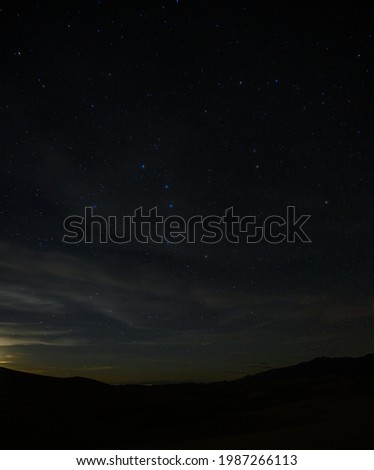 Stars and Clouds Over Sand Dunes in Colorado
