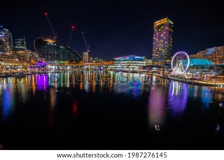 Panoramic night view of Sydney Harbour and City Skyline of Darling Harbour and Barangaroo Australia bright neon lights reflecting off the water