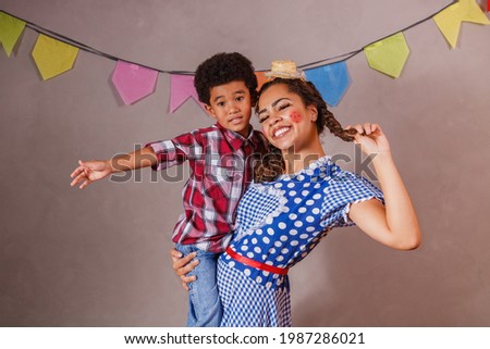 Afro mother and son dressed for June party