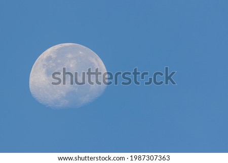 closeup view of a Waxing cresent moon in the blue sky
