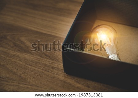 Light bulb in the black box. Concept of inspiration creative idea thinking and future technology innovation