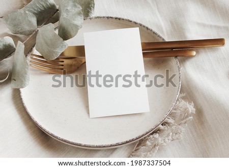 Menu card mockup on empty modern minimal table place setting neutral beige color.  Space for text. Scandinavian style tableware.