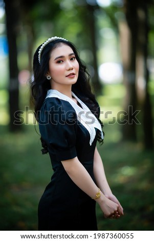 Ho Chi Minh city, Viet Nam: Portrait of a beautiful Vietnamese girl taking pictures in the park 