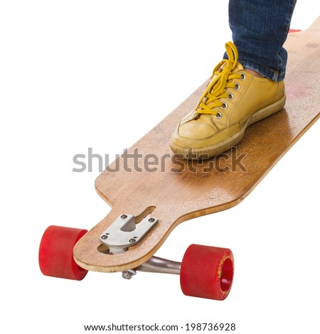 Feet standing on longboard skateboard isolated on a white background.