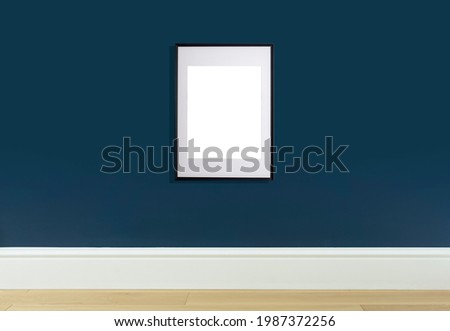 Mock up poster frame in interior wall. White frame for poster or photo image on blue wall in home room or office interior