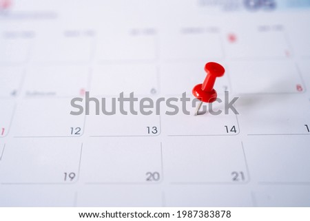 Picture of red pin embroidered the 14th on the calendar in February. Selective focus.