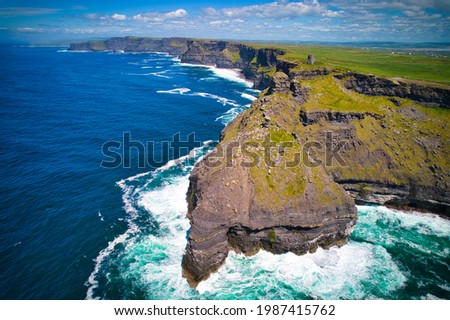 Aerial photo of Cliffs of Moher with Moher Tower over the cliffs.