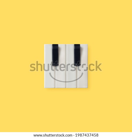 Creative square emoticon made of piano keys isolated on illuminating yellow background. Aesthetic, abstract, positive emotions music concept. Happy face emoji. Minimal flat lay. Wallpaper idea. Royalty-Free Stock Photo #1987437458