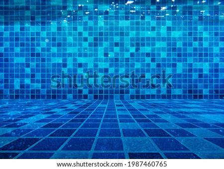 Clear Water at the Bottom of the Swimming Pool Empty Space Blue Tiles Background