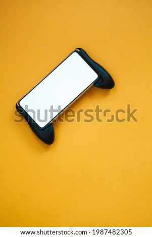 Joystick mobile phone, screen mockup Isolated on yellow background, top view