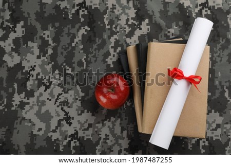 Books, apple and diploma on camouflage background, flat lay with space for text. Military education concept