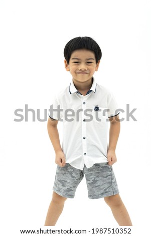 Picture of asian boy with smiling face standing on white background. Looking at camera.