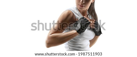 Croped portrait of fitness confident sporty female model with power hands in gloves isolated on white. Copy space. Female bodybuilder wearing gloves ready for gym exercise.