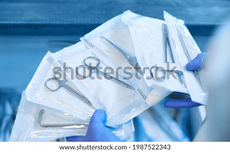 Packaged dental products in sealed sealed packaging. The concept of sterilization and disinfection in a modern dental clinic. Royalty-Free Stock Photo #1987522343