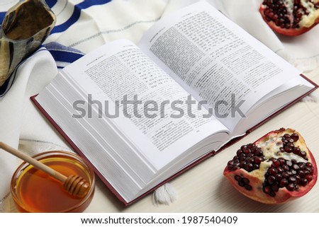 Composition with Rosh Hashanah holiday symbols on white wooden table