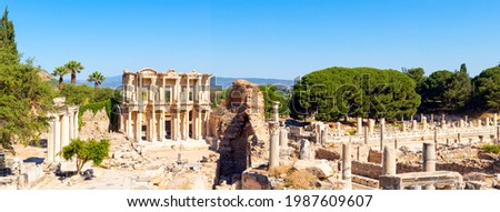 Photo of Celsius library and marble columns in the ephesus ancient city on a partly cloudy day. Cultural and historical tourism concept.