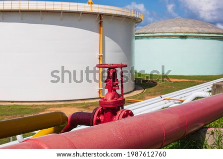 Row of large white tanks for petrol pipeline oil and gas